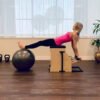 Pilates chair with spring-loaded resistance system